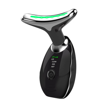 Black facial beauty massager with green light shown at the head