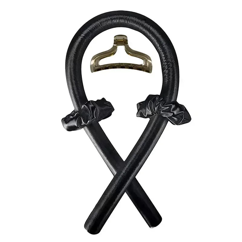 Black heatless curling rod with two black scrunchies and a hair clip