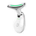 White facial beauty massager with green light shown at the head